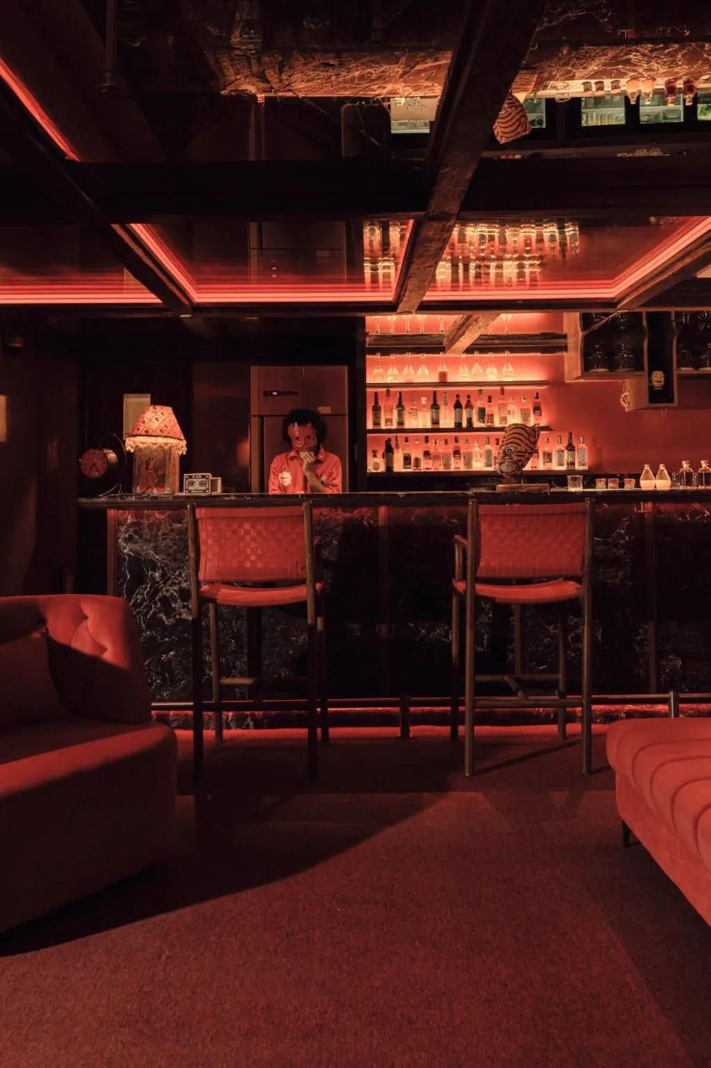 Moody cocktail bar with amber backlight and craft drinks